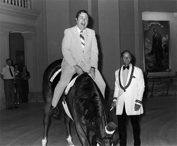 photograph of Governor David Boren astride a horse inside the state capitol